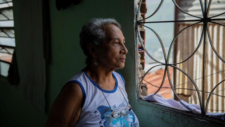 Hilda Márquez, de 76 años, mira por la ventana el lunes 29 de junio en su casa del barrio Guaicaipuro de Catia, en Caracas (Venezuela).