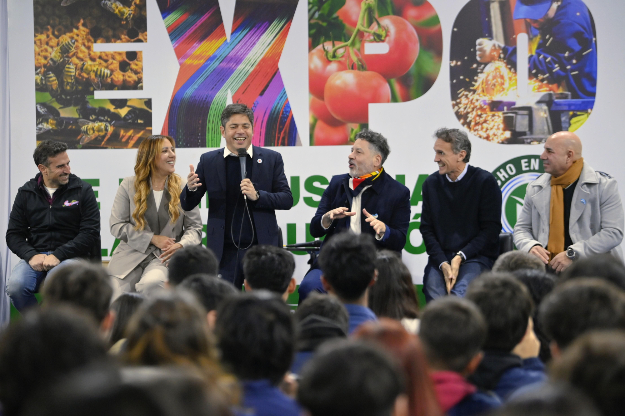 Axel Kicillof habla en la exposición Hecho en Merlo el 4 de septiembre de 2025. A su derecha, el intendente Gustavo Menéndez y el ministro y candidato Gabriel Katopodis