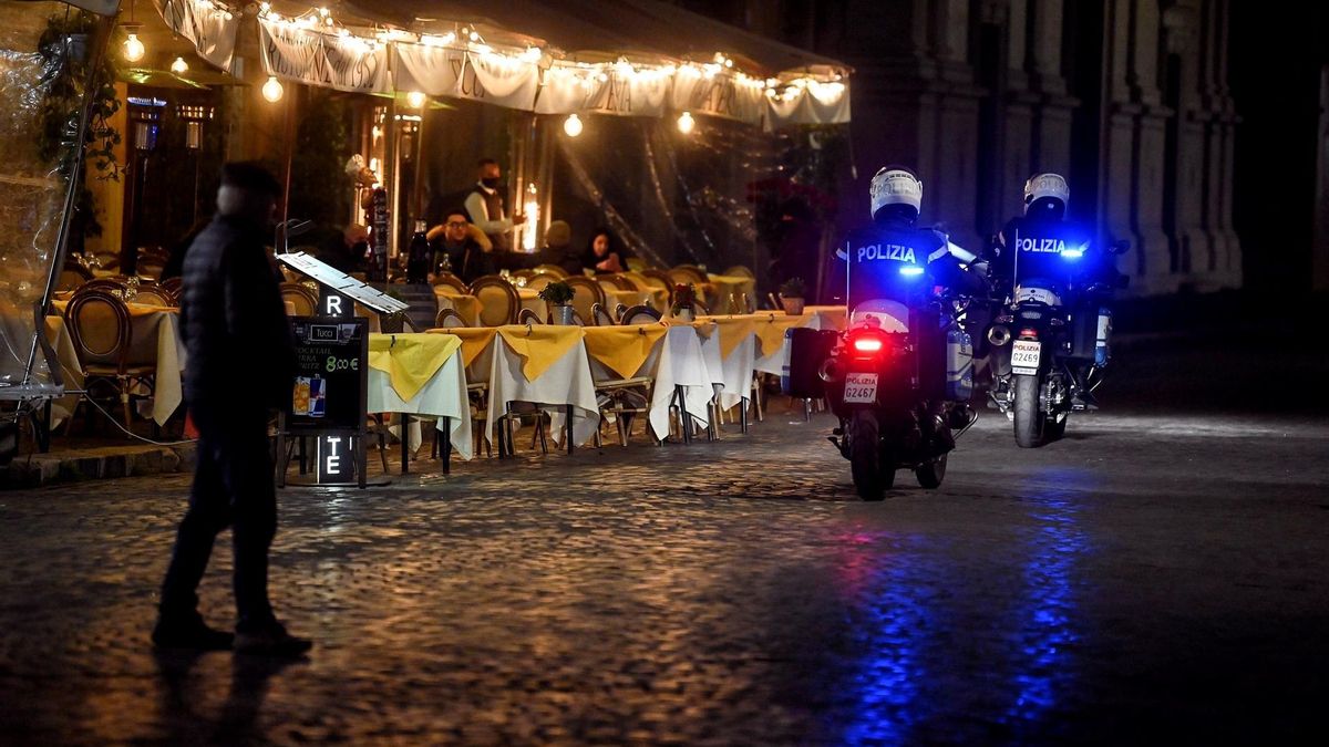 Police on motorcycles patrol next to empty tables at a restaurant in piazza Navona due to the cold weather and Covid-19 restrictions, in the centre of Rome, Italy, 23 February 2021.