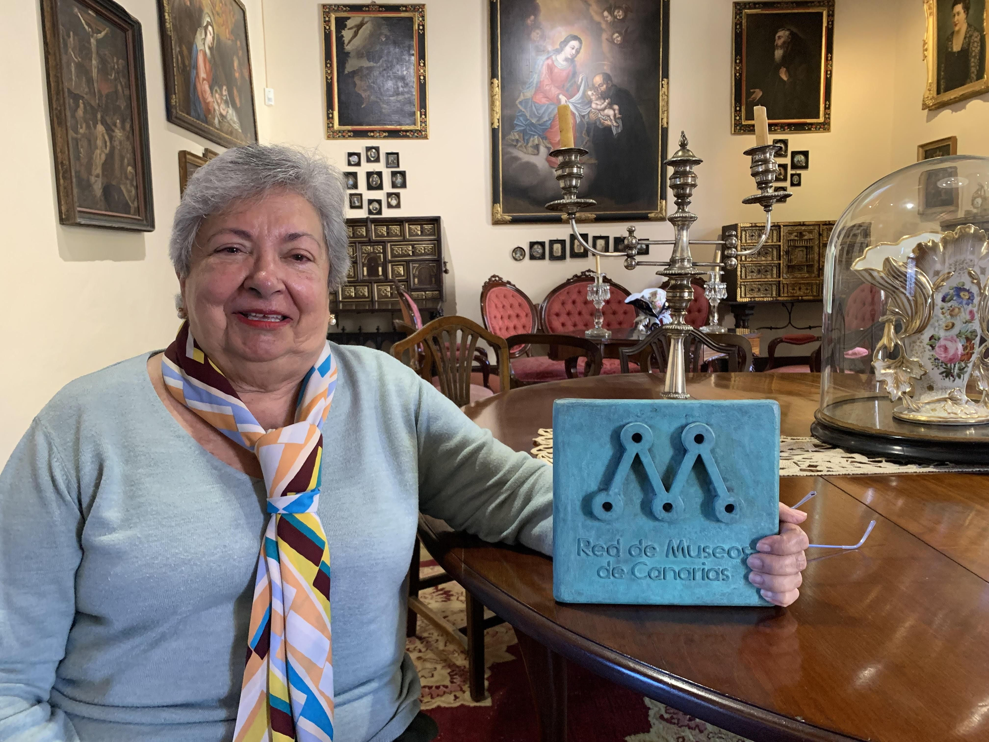 María Remedios Gómez García muestra la placa de la Red de Museos de Canarias.