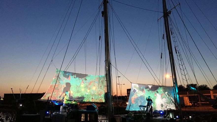 Actuación de Filastine en el barco, acompañada de proyecciones sobre las velas