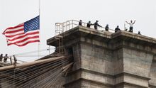 New York City Police officers talk to a man who climbed atop the Brooklyn Bridge in Brooklyn, New York, USA, 22 May 2020.