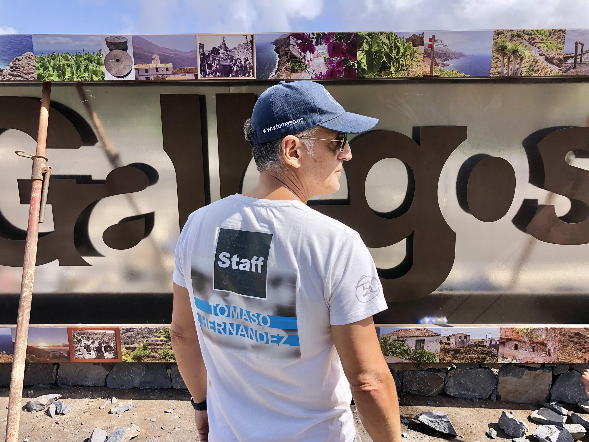 Tomaso Hernández junto al cartel que realiza en el barrio de Gallegos.