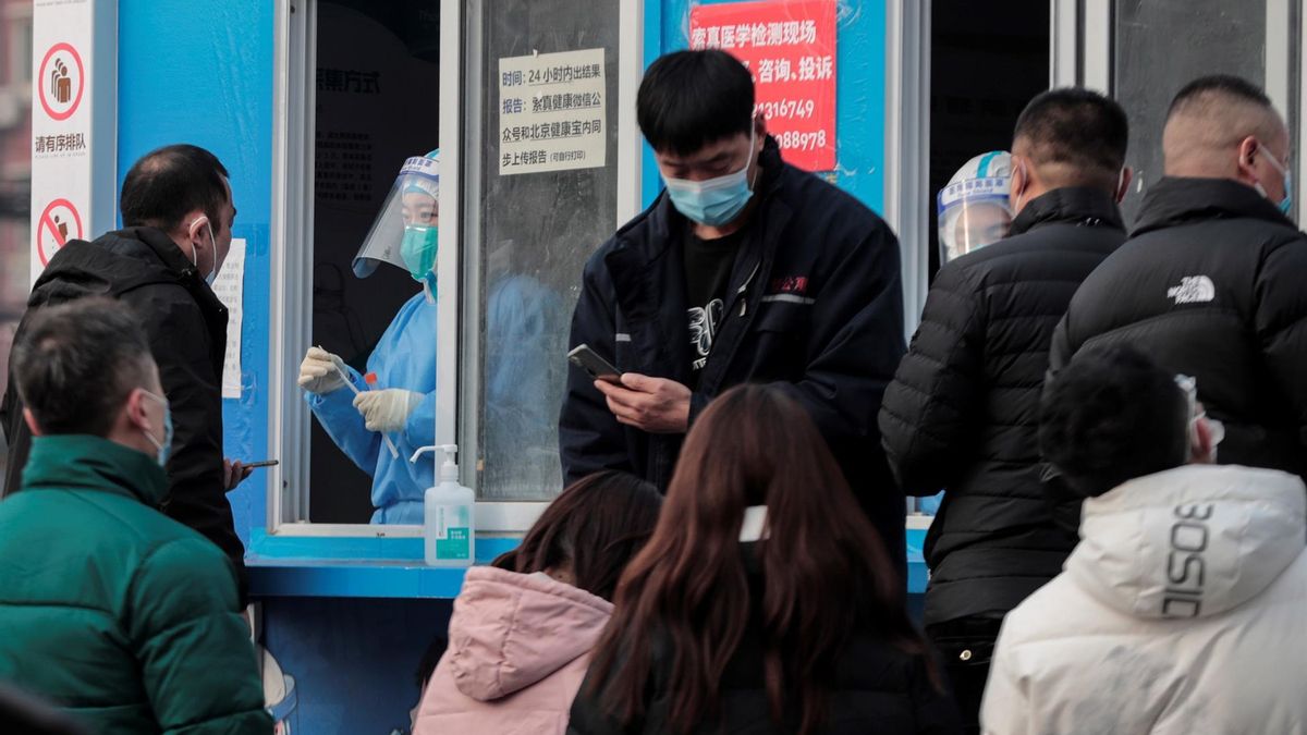 People wearing face masks gather for COVID-19 nucleic acid testing in Beijing, China, 30 January 2022. The Chinese mainland on 29 January recorded 54 locally transmitted COVID-19 cases including 20 cases were reported in China's capital Beijing.