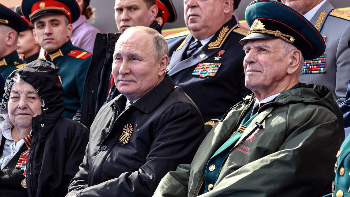 El presidente ruso, Vladímir Putin, sentado entre veteranos de la Segunda Guerra Mundial durante el desfile del Día de la Victoria, el 9 de mayo de 2022, en Moscú.