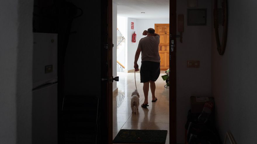 Antonio, uno de los afectados, deja su casa con su perro.