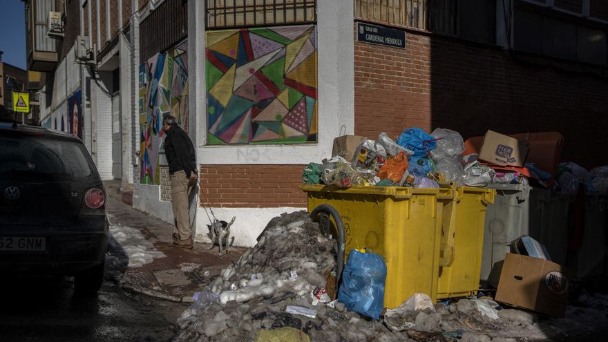 Contenedores de basura llenos junto con restos de hielo y nieve en la calle Cardenal Mendoza del barrio Puerta del Angel, Madrid.