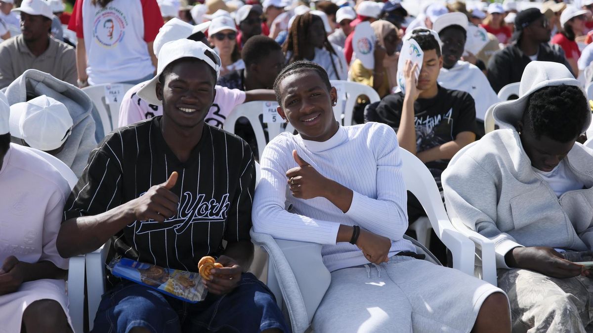 Varios migrantes asisten al encuentro con el papa León XIV en el puerto de Arguineguín, en la isla de Gran Canaria, este jueves, en el sexto día del viaje de León XIV a España.