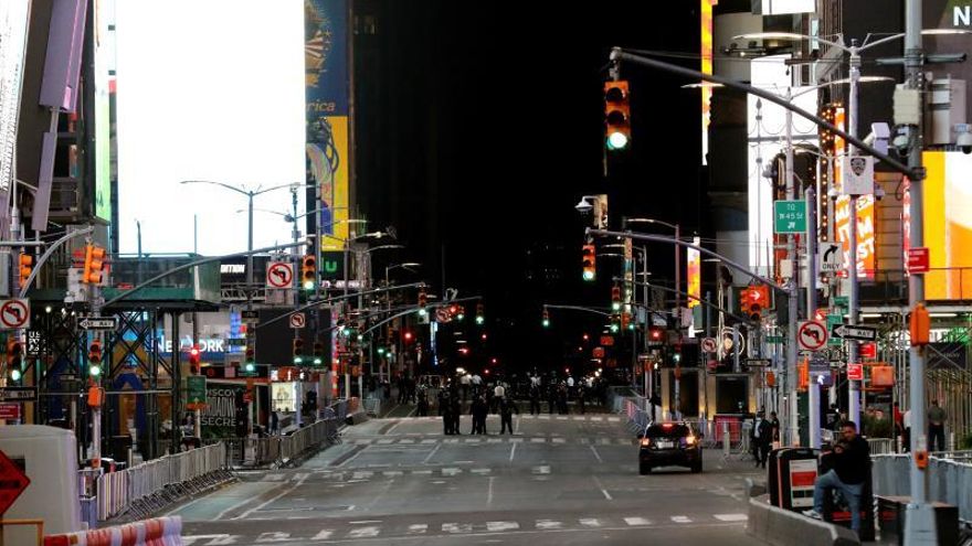 Police stand guard at Times Square to prevent possible looting and vandalism during protests over the death of George Floyd, who died in police custody, in Manhattan, New York, USA.