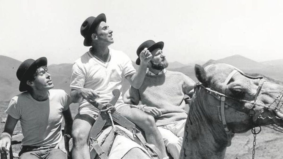 Pepe Dámaso, César Manrique y Manolo Millares sobre un camello en lanzarote.