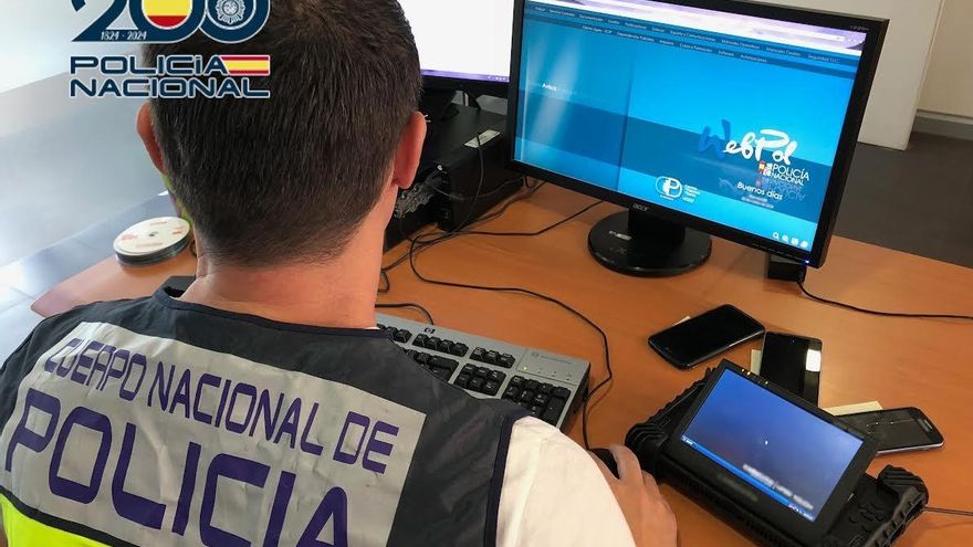 Archivo - Un agente de la Policía frente a un ordenador