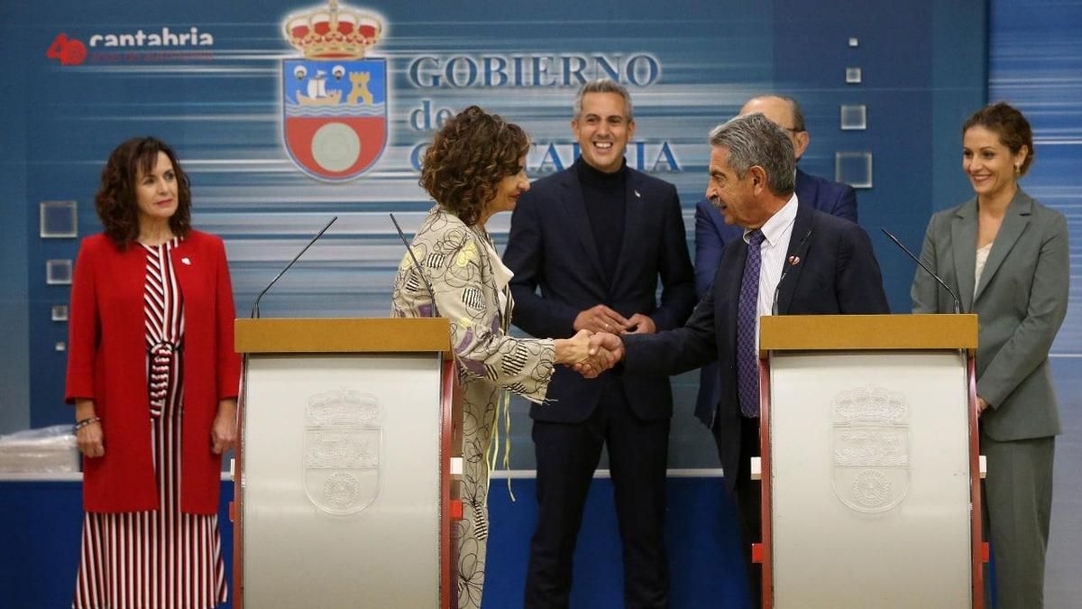 Montero y Revilla se dan la mano durante la rueda de prensa.