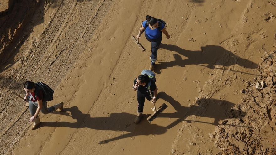 Tres voluntarias limpian las calles de Catarroja, Valencia este martes, una de las localidades más afectadas por las inundaciones.