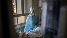 Una fisioterapeuta trata a un paciente con COVID-19 en la UCI del hospital. Los pacientes que pasan muchas semanas ingresados necesitan que les ejerciten las articulaciones.