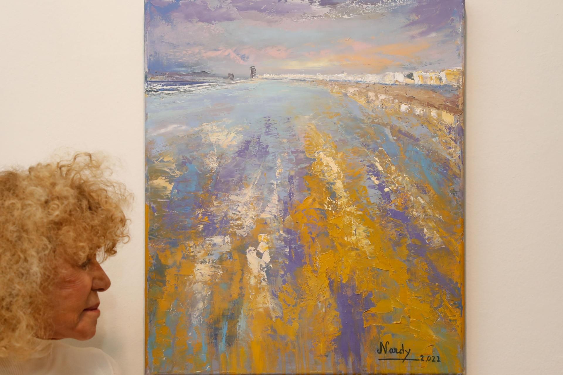 La exdiputada María Bernarda Barrios, junto a su cuadro para la subasta benéfica