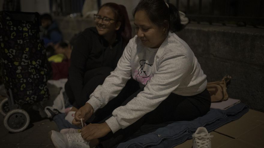 Hilary (izquierda) y su madre (derecha) esperando la cola en los servicios sociales de Madrid