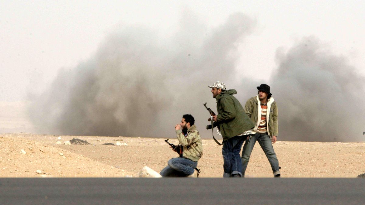 Combatientes rebeldes responden al fuego durante un bombardeo de soldados leales al líder libio Muamar Gadafi en una batalla cerca de Ras Lanuf, el 4 de marzo de 2011.
