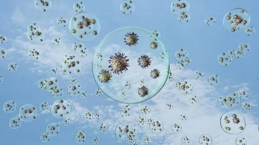 Recreación artística de coronavirus flotando en el aire dentro de gotitas, exagerando mucho el tamaño de los virus respecto al de las gotitas. En la realidad son mucho más pequeños. / Adobe Stock