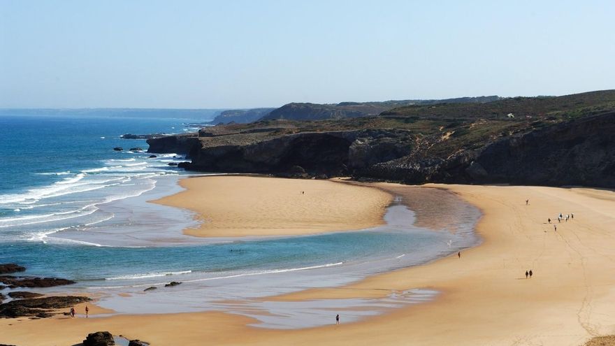 La espectacular playa salvaje de arena dorada y rodeada de acantilados, dunas y perfecta para hacer surf en Portugal