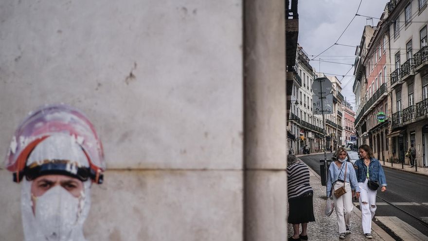 People walk by Bairro Alto in Lisbon, Portugal, 18 June 2021. The Portuguese cabinet announced on 17 June the ban on circulation to and from the Lisbon Metropolitan Area (AML) on weekends, starting at 15:00 on 18 June, due to the rise in cases of Covid-19 in this territory.