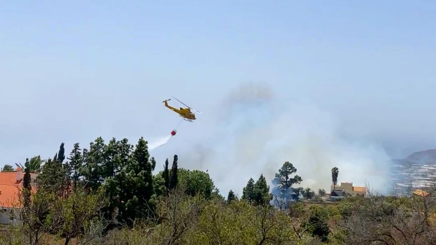 Un helicóptero descarga agua en el incendio declarado este martes en La Palma. MIGUEL CALERO/EFE