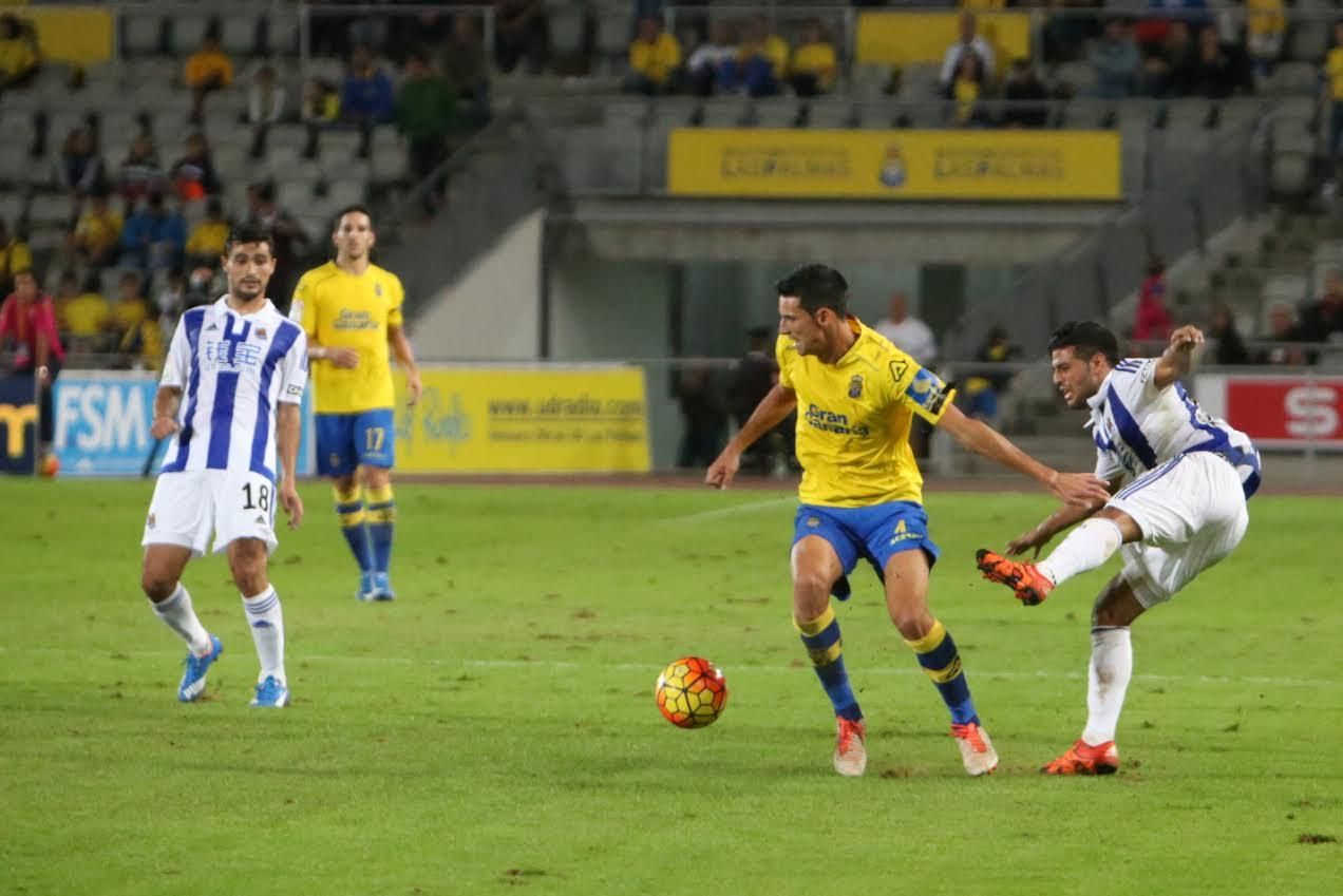 Vicente Gómez esconde el balón ante la presión de un jugador de la Real Sociedad.