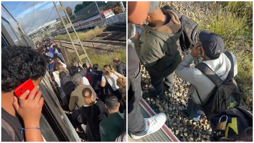 Pasajeros andando por las vías en la entrada a Atocha por una avería en el Cercanías de Madrid