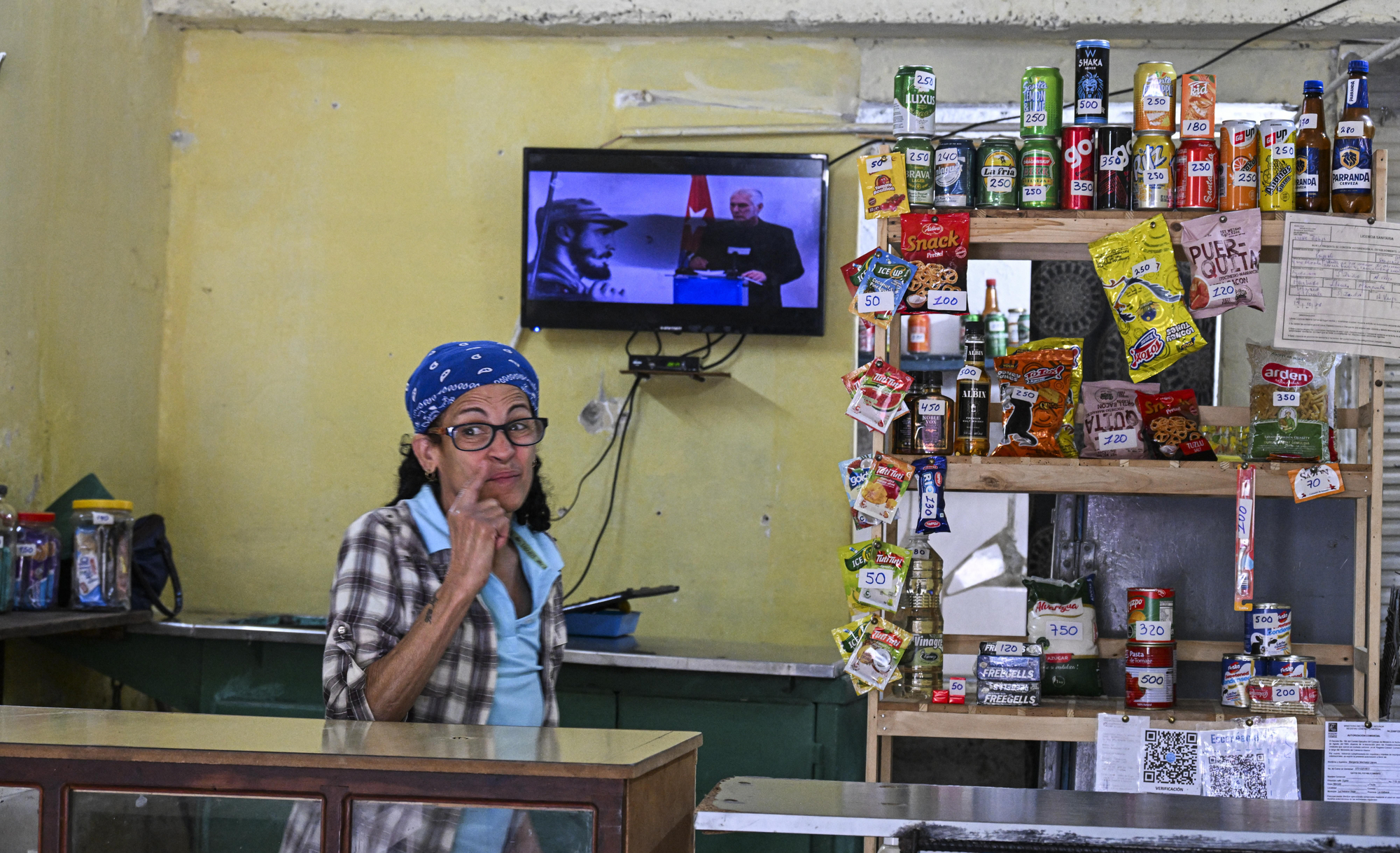 Una mujer escucha al presidente cubano, Miguel Díaz-Canel, hablando en la televisión, en una tienda en La Habana el 5 de febrero de 2026.