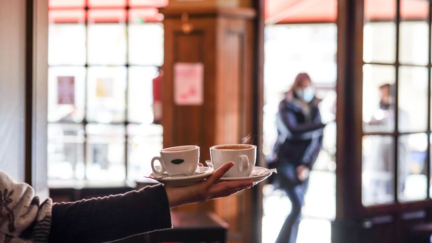 Archivo - Un camarero sirve varios cafés en una cafetería de Vitoria