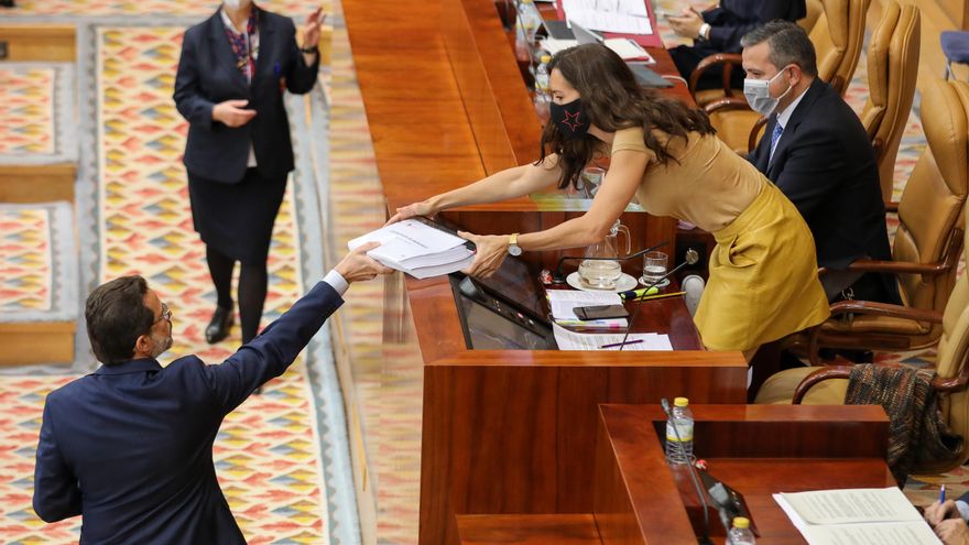 El consejero de Hacienda, Javier Fernández-Lasquetty entrega a la presidenta de la Asamblea de Madrid , Eugenia Carballedo copias de contrataciones de emergencia en la región por la crisis del Covid-19