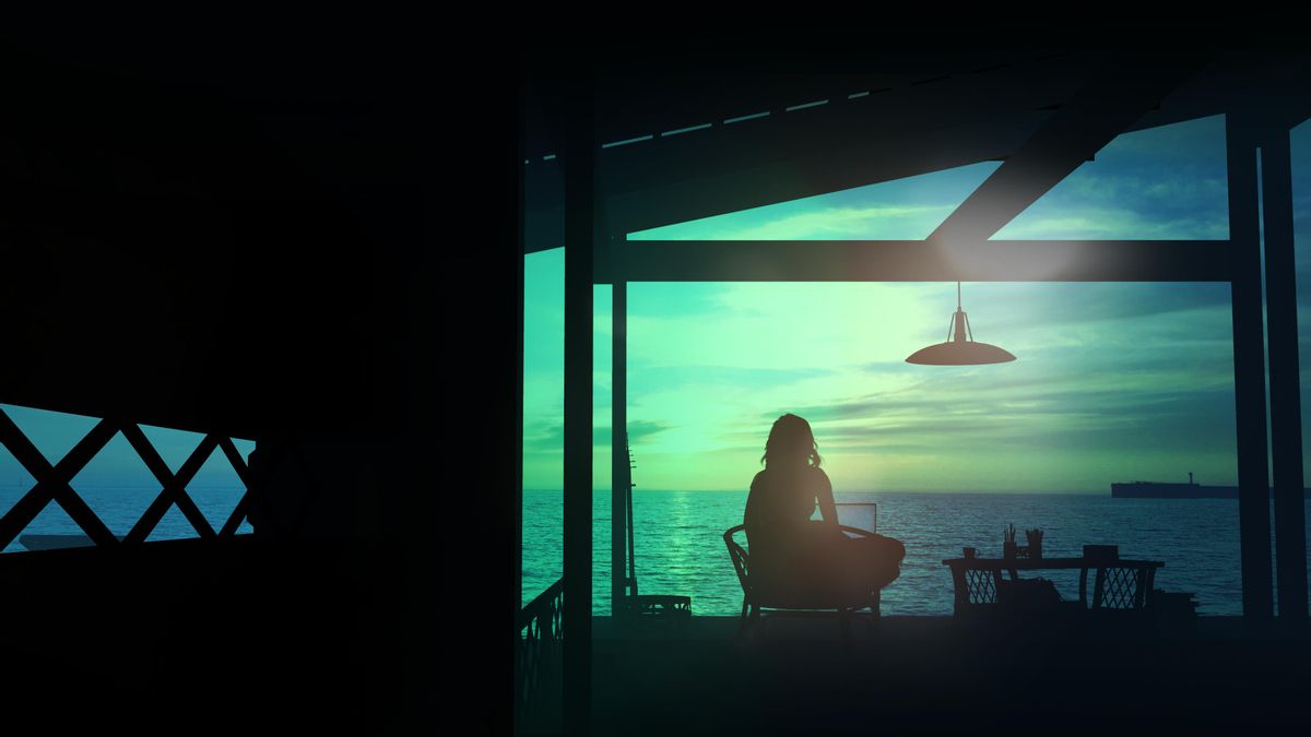 Mujer teletrabajando con vista al mar