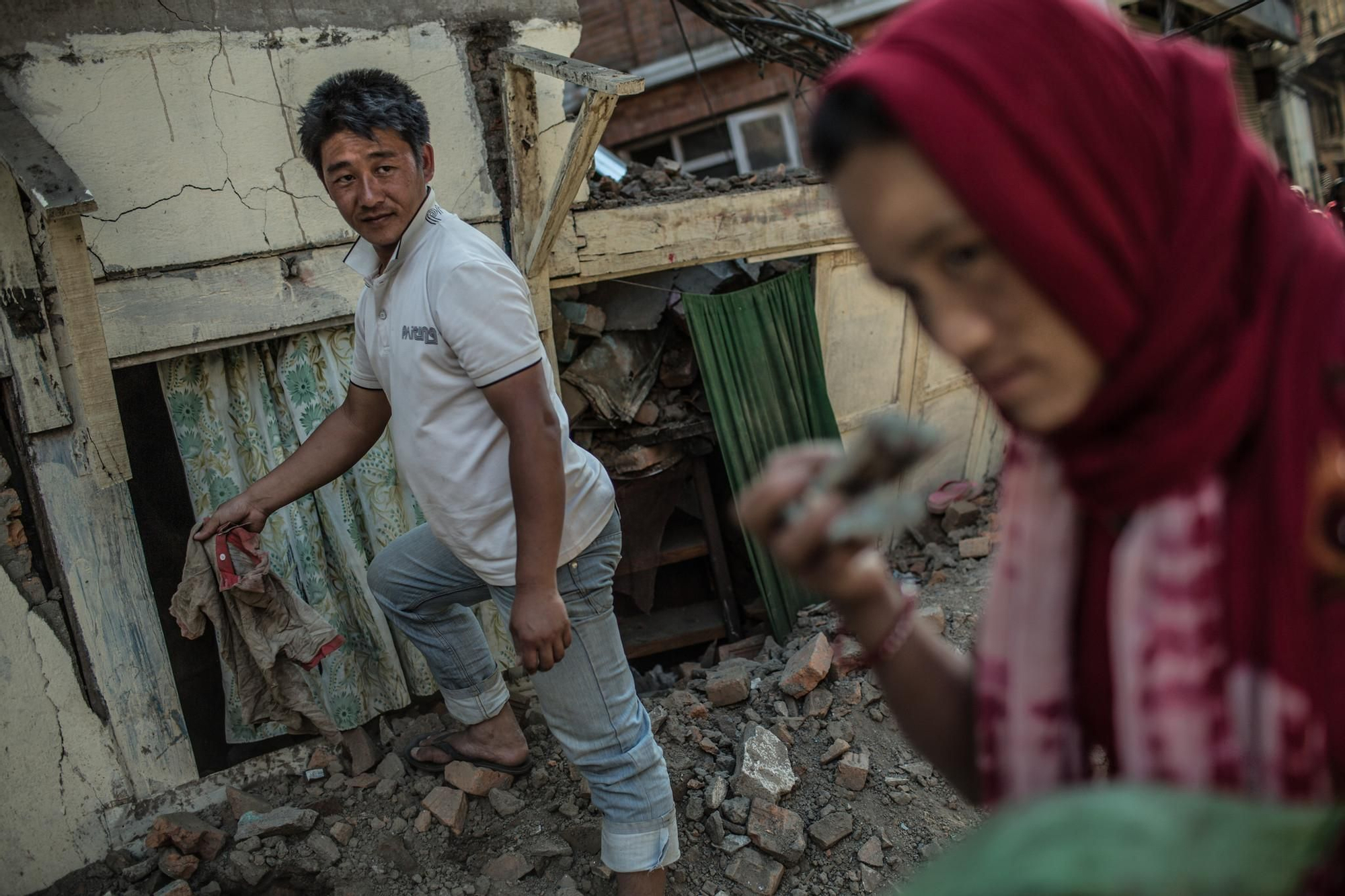 Tika junto a su marido Ramesh empiezan a remover escombros en busca de alguna pertenencia que puedan recuperar./ Pablo Tosco (Oxfam Intermón).