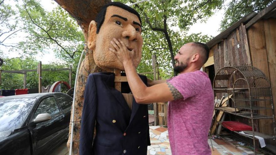 Un joven elabora un monigote con la imagen de Juan Antonio "Tony" Hernández, este domingo, en Germania (Honduras). Las figuras del presidente de Honduras, Juan Orlando Hernández, y la de su hermano Juan Antonio "Tony" Hernández, quien fue declarado culpable en EE.UU. por narcotráfico, serán quemadas el próximo martes en la capital del país para despedir el 2019 y recibir el 2020.