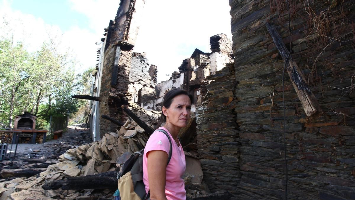 Silvia Vergara, vecina de Lusío (Oencia), junto a su casa arrasada por el fuego.
