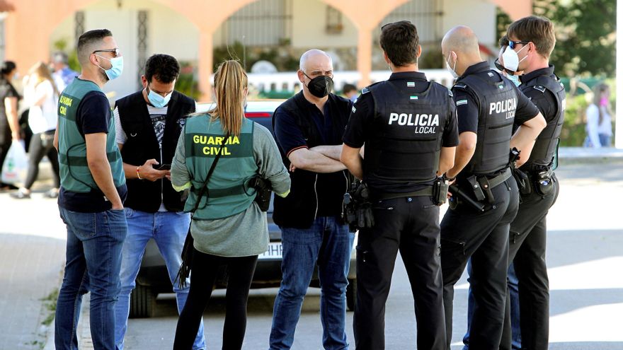 Guardias civiles y policías locales esperando ayer la autorización judicial para entrar en la casa