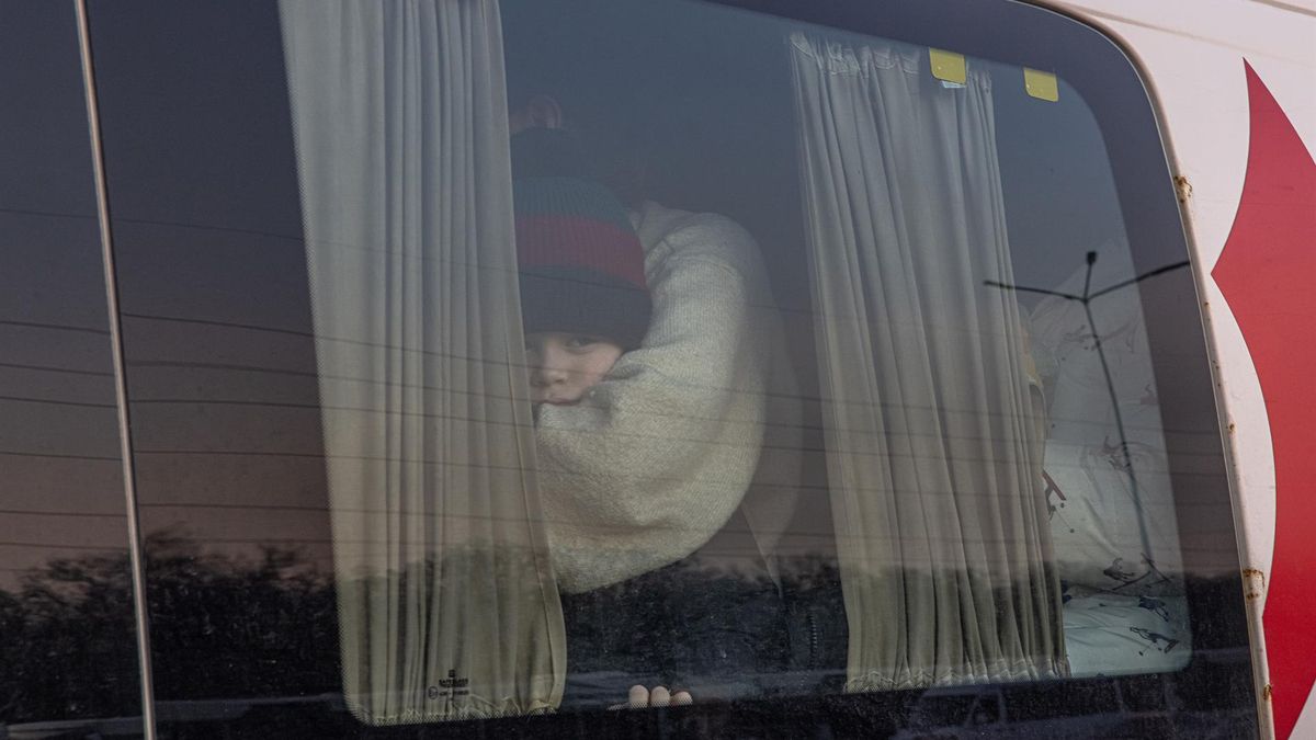A child sits in a minibus as he with other people who fled from the besieged by Russian military southeastern city of Mariupol and occupied Melitopol arrive at the evacuation point in Zaporizhzhia, Ukraine, 25 March 2022.