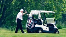 US President Donald J. Trump, wearing a white hat and white Polo shirt, plays golf at the Trump National Golf Club in Sterling, Virginia, USA, 23 May 2020.
