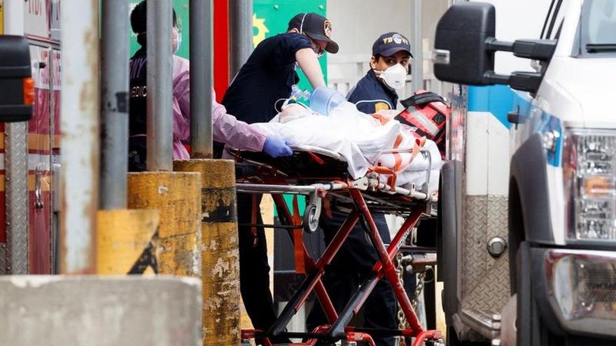 Paramedics bring a patient into the emergency room at Elmhurst Hospital Center in Queens, New York, USA, on 14 April 2020.