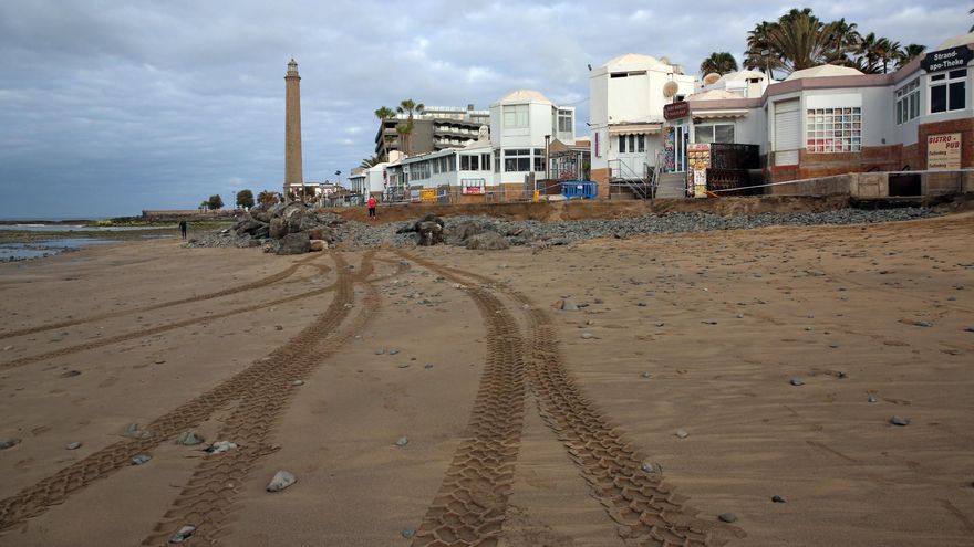 Vista desde el arenal de los efectos causados por la pleamar en un tramo de la playa de Maspalomas, con la escollera al fondo.