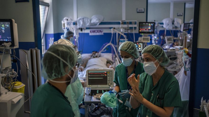 Tres sanitarias salen del box en el que está ingresado un paciente de coronavirus en el Hospital 12 de Octubre de Madrid