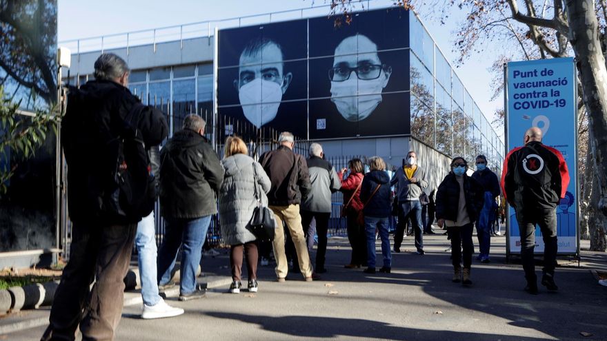 Decenas de ciudadanos guardan su turno en cola para accecer al centro de vacunación instalado en la Fira de Barcelona este lunes.