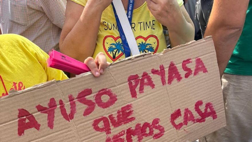 Noa, de 10 años, sujeta un cártel pintado por ella misma con el lema "Ayuso, payasa, que no tenemos casa" en la acampada en Sol por la vivienda que ha confluido con la manifestación por la educación pública