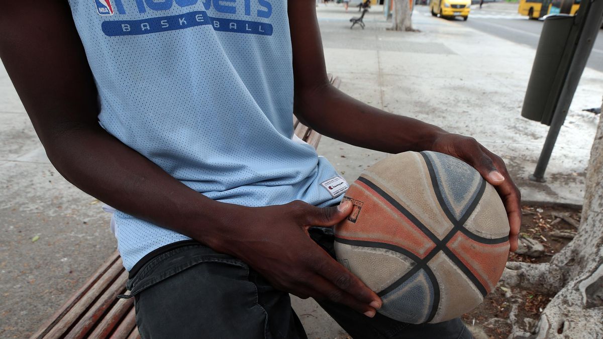 Moussa sostiene su balón de baloncesto.