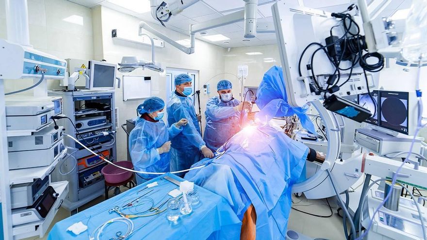 Personal de una unidad de cuidados intensivos atendiendo a un paciente con covid-19. / Adobe Stock