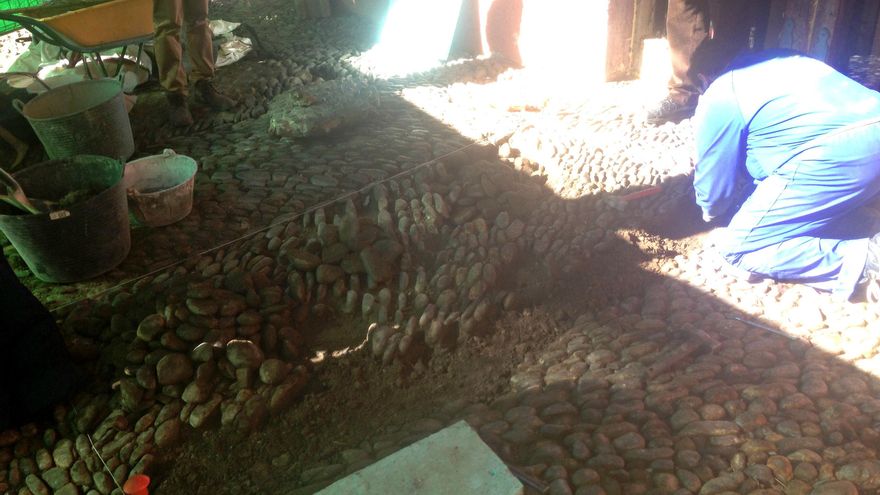 Operarios de la empresa subcontratada levantando el enchinarrado del soportal de La Piconera esta mañana.