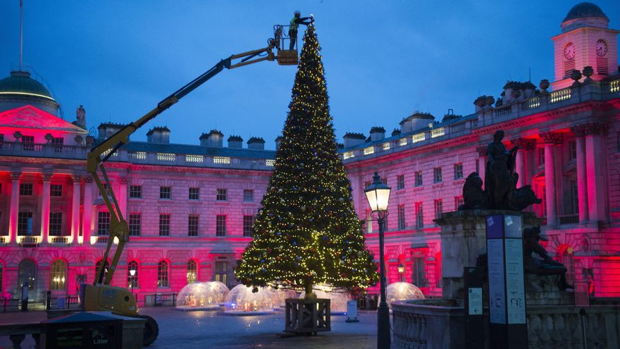 Un operario coloca las luces en el árbol de Navidad de la Somerset House en Londres.