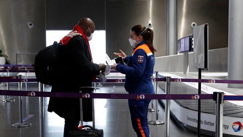 A traveller talks to a member of Civil Protection as he arrives for a COVID-19 test at Paris Charles de Gaulle airport in Roissy near Paris, France, 05 February 2021, as France closed borders to travelers outside European Union due to restrictions against the spread of the coronavirus disease (COVID-19).