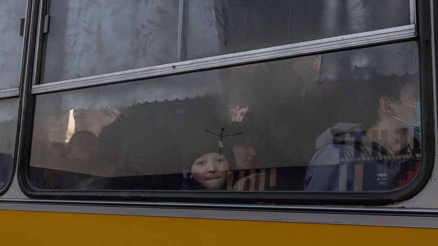 Evacuees sit on a bus as they with other people who fled from the besieged by Russian military southeastern city of Mariupol and occupied Melitopol arrive at the evacuation point in Zaporizhzhia, Ukraine, 25 March 2022.