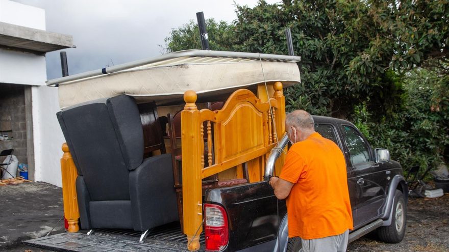 Un hombre carga sus enseres en una furgoneta en la localidad de La Laguna. EFE/ Elvira Urquijo A.