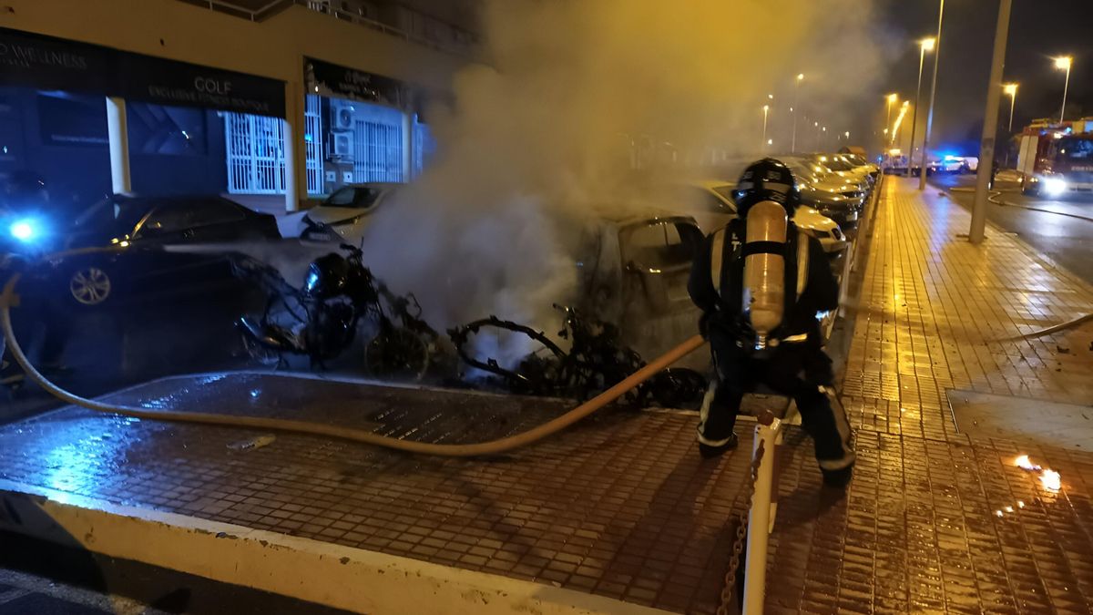 Firefighters extinguish a blaze caused by a motorcycle, which spread to nearby vehicles in Adeje.